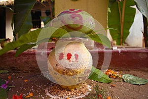 A sacred vessel with mango leaves and green coconut generally used in marriage ceremony or to worship in India
