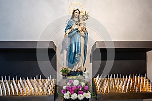 Virgin Mary with Son Jesus about sacrificial candles in Church of Bressanone, - Brixen - in Alto Adige, South Tyrol, Italy photo