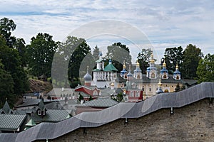 Sacristy, belfry, Uspensky Assumption cathedral in the Pskov-Caves Holy Dormition Monastery behind the fortress wall. Pechory,