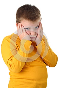 Sad 10 year old boy holding his cheeks isolated