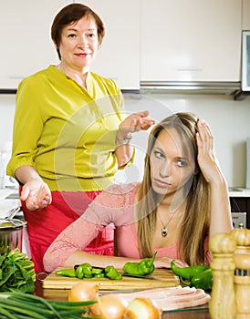 Sad adult daughter against mature mother after conflict