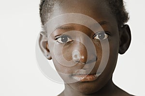 Sad African child showing her face for a portrait, sadness despair symbol, isolated on white