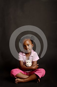 Sad African little girl sitting alone