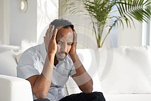 Sad african man lies on the bed