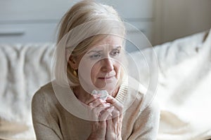 Sorrowful aged lady grieve for beloved husband photo