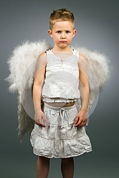 Sad angel kid with white wings