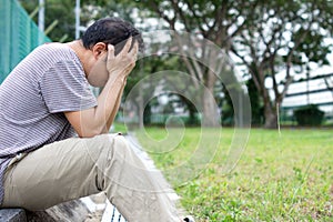 Sad Asian Chinese Man with face in hands