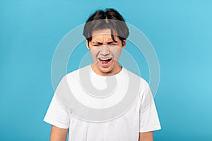 Sad Asian Teen Guy Shouting Loudly Crying Over Blue Background