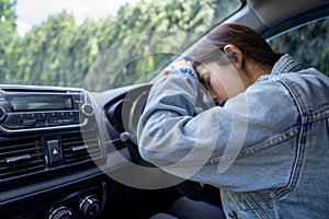 Sad Asian woman in the car, she is involved in a car accident