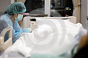 Sad asian woman or nurse in face mask and medical uniform pray with closed eyes hands clasped together say a prayer for senior photo