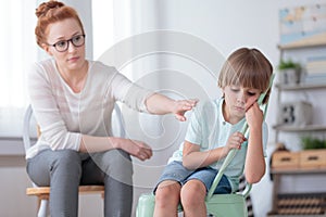 Sad autistic boy and psychotherapist