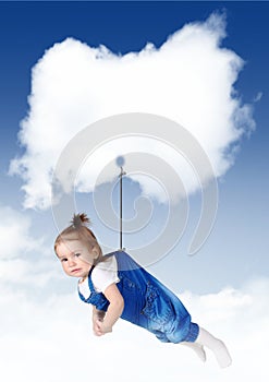 Sad baby girl flying on a cloud with copy space