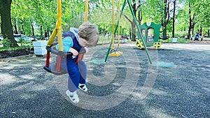 Sad baby on the swing