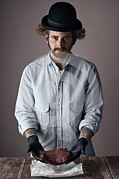 Sad bearded man with curly hair in black hat steak