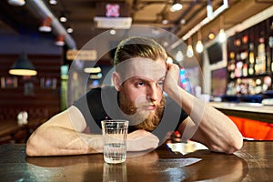 Sad Bearded Man Getting Drunk in Bar