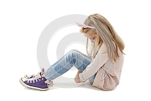 Sad beautiful little girl, sitting on floor