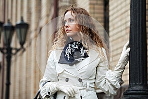 Sad beautiful woman at lamppost