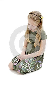 Sad beautiful young girl, sitting on floor