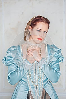Sad Beautiful young woman in medieval style blue dress