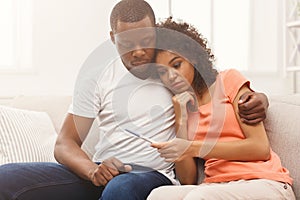 Sad black couple after pregnancy test result