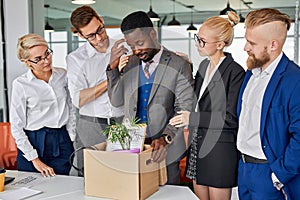 Sad black male is supported by colleagues