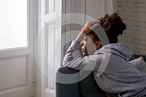 Sad black woman suffering from depression symptoms feeling distressed alone at home