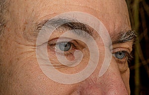 Sad blue eyes of an aging man