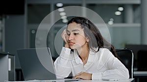 Sad bored lazy young woman typing on laptop tired unmotivated businesswoman office worker feels fatigue from working at