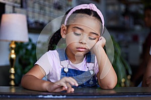 Sad, bored and lonely kid in home, depressed or upset while thinking alone in house. Loneliness, depression and anxiety