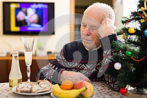 Sad older man celebrating New Year alone during pandemic