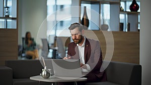 Sad boss feeling disappointed looking laptop computer screen at office workplace