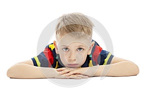 Sad boy with big blue eyes in a bright T-shirt, close-up. Isolated on a white background