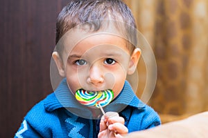 Sad boy eating Lollipop
