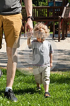 Sad boy leaving playground