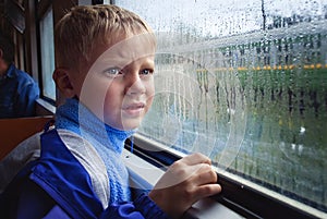 SAD BOY LOOKS IN WINDOW