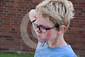 Sad boy with new glasses