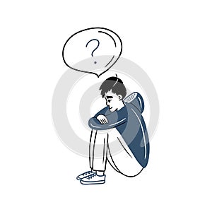 Sad boy is sitting and holding his legs and trying to solve his problems and find the answers. Blue hoodie teenager. School
