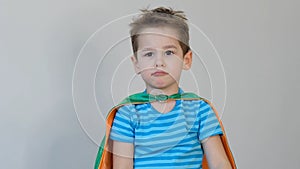 Sad boy superhero. little boy playing a superhero. Kid in an Superhero`s costume. child green mask, nature care concept