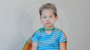 Sad boy superhero. little boy playing a superhero. Kid in an Superhero`s costume. child green mask, nature care concept