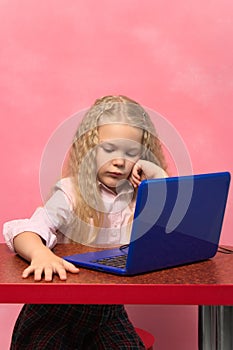 sad, brooding schoolgirl behind the lepton. pink background.