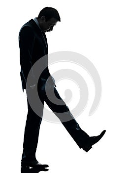 Sad business man looking down silhouette