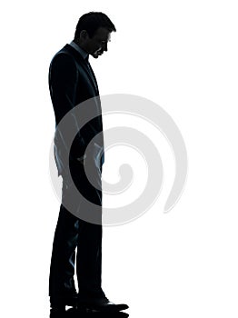 Sad business man looking down silhouette