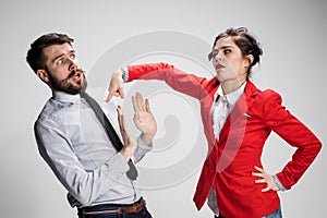 The sad business man and woman conflicting on a gray background