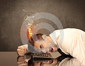 Sad business person`s head catching fire