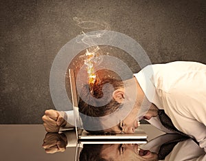 Sad business person`s head catching fire