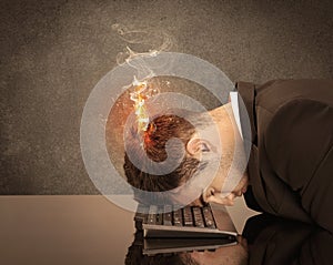 Sad business person`s head catching fire