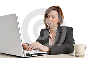 Sad business red haired woman in stress at work with computer