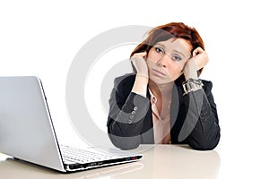 Sad business red haired woman in stress at work with computer