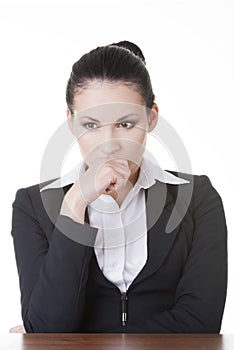 Sad business woman sitting behind the desk