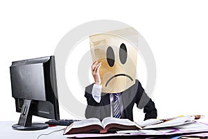 Sad businessman with cardboard head